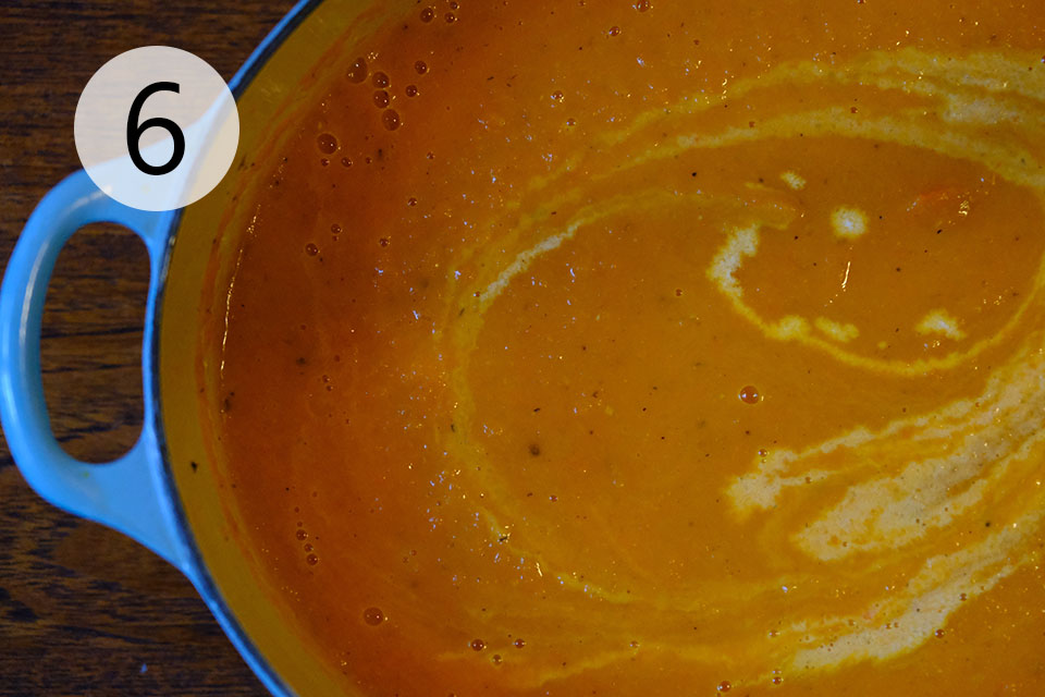 Add cream to roasted carrot and brie soup