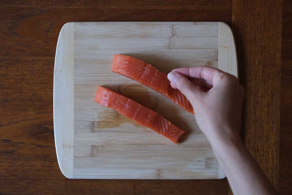 Prepping salmon on a cutting board