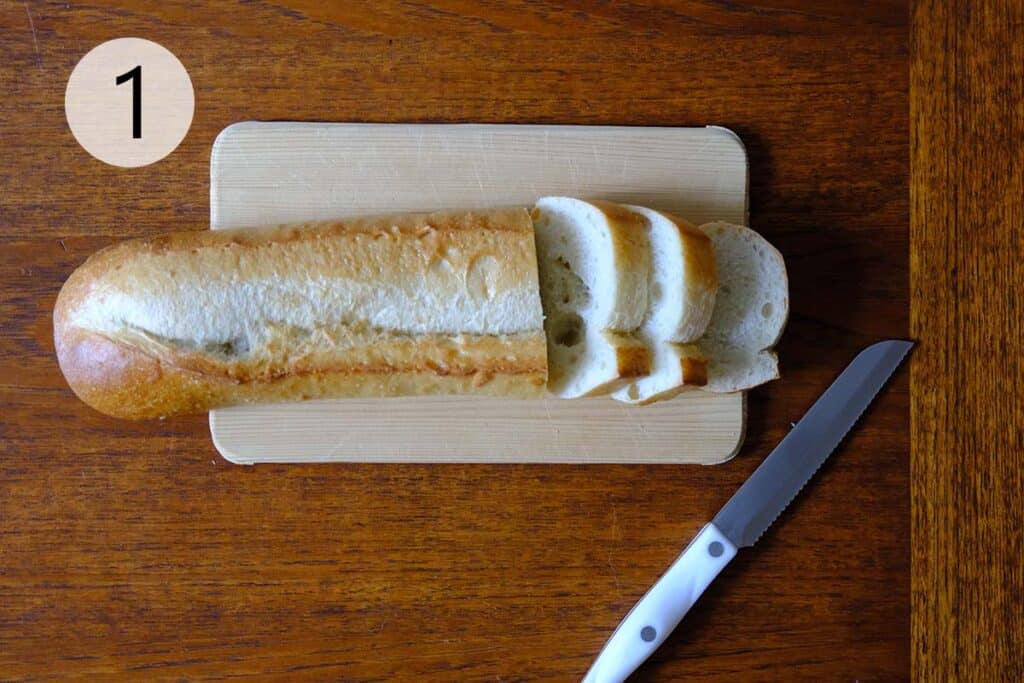 A bread cut in half on a cutting board.
