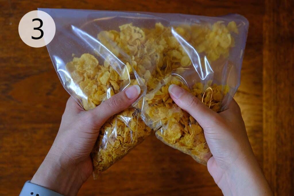 Crushing the cornflakes for the crispy cornflake coating for French Toast.