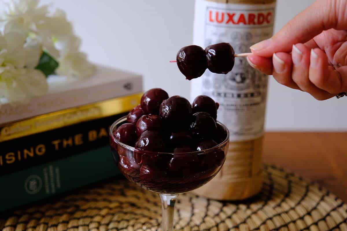 Homemade maraschino cherries made with Luxardo liqueur, displayed in a cocktail glass for easy at-home garnish.