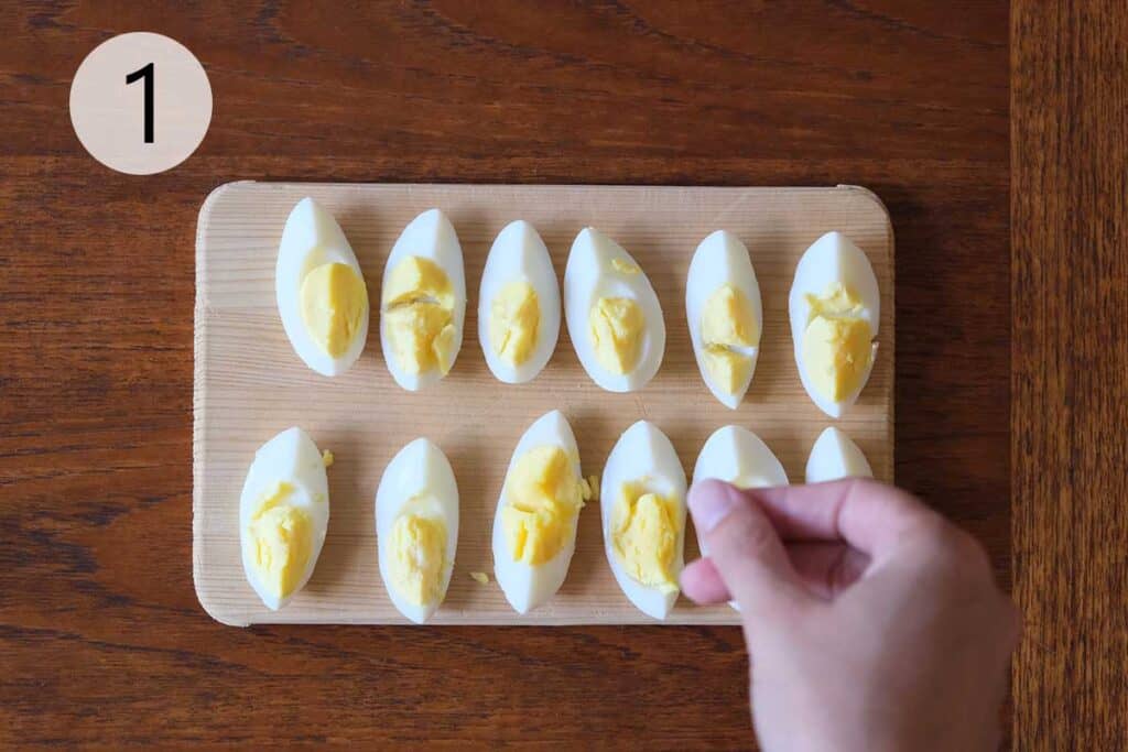 Quartered hard-boiled eggs sprinkled with salt, ready to add to salad.