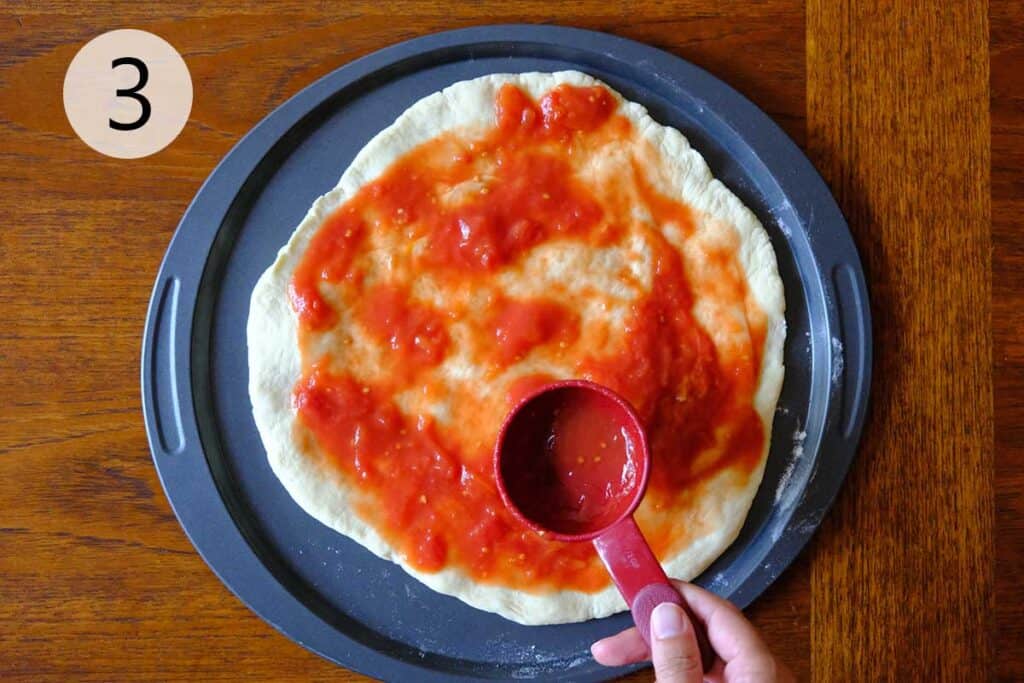 Finished 2 ingredient Neapolitan pizza sauce ready to spread on Neapolitan pizza dough for homemade margherita or anchovy pizza.