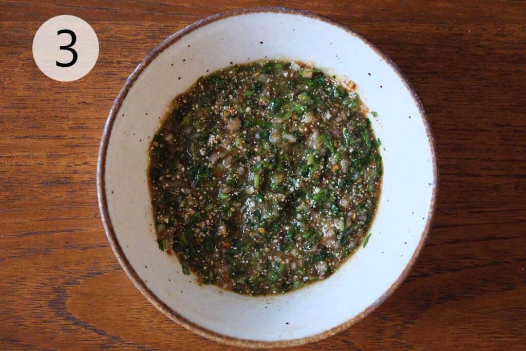 Finished Nam Jim Jeaw sauce in a serving bowl, perfect for dipping grilled meats, sticky rice, and Thai-inspired dishes.