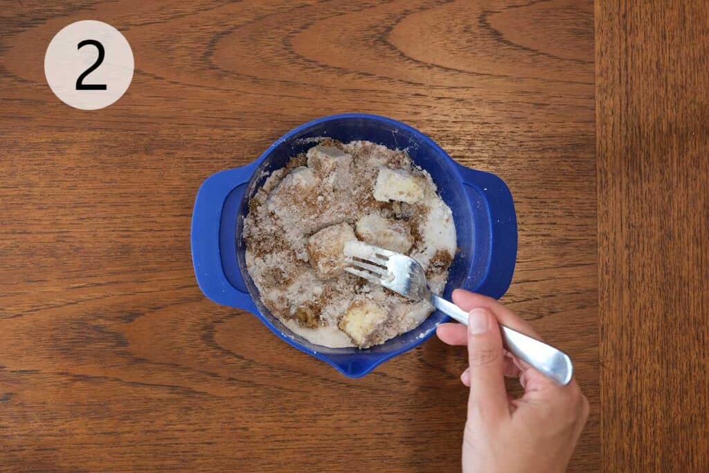 Bowl with crumb topping mixture of sugar, cinnamon, butter, flour, and walnuts for zucchini and orange muffins.