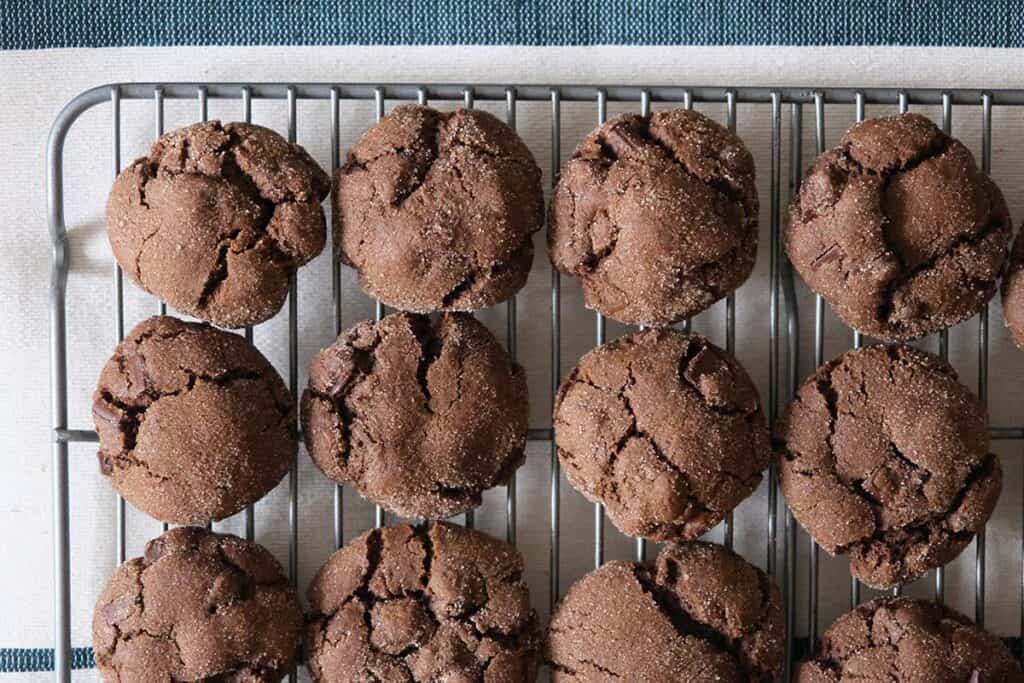Freshly baked Mexican Chocolate Cookies with chewy centers and sugared edges cooling on a baking sheet.