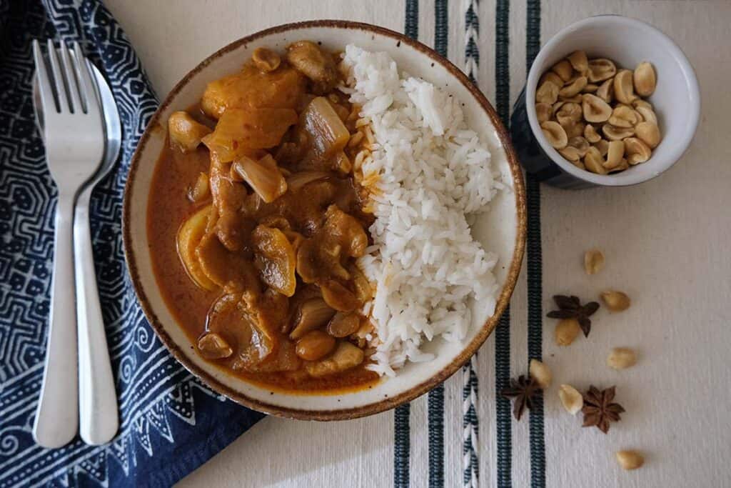 Served Chicken Massaman Curry Recipe over steamed jasmine rice, topped with roasted peanuts for a comforting Thai-inspired dinner.