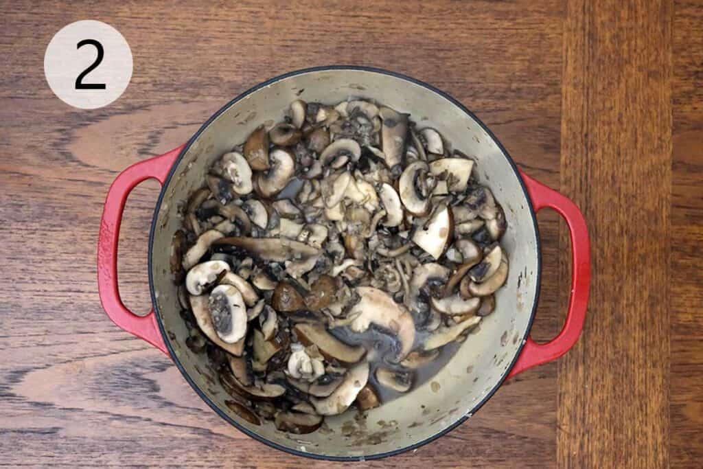 A mix of cremini, oyster, and chanterelle mushrooms browning in a pot to build deep flavor for the creamy wild mushroom soup recipe.
