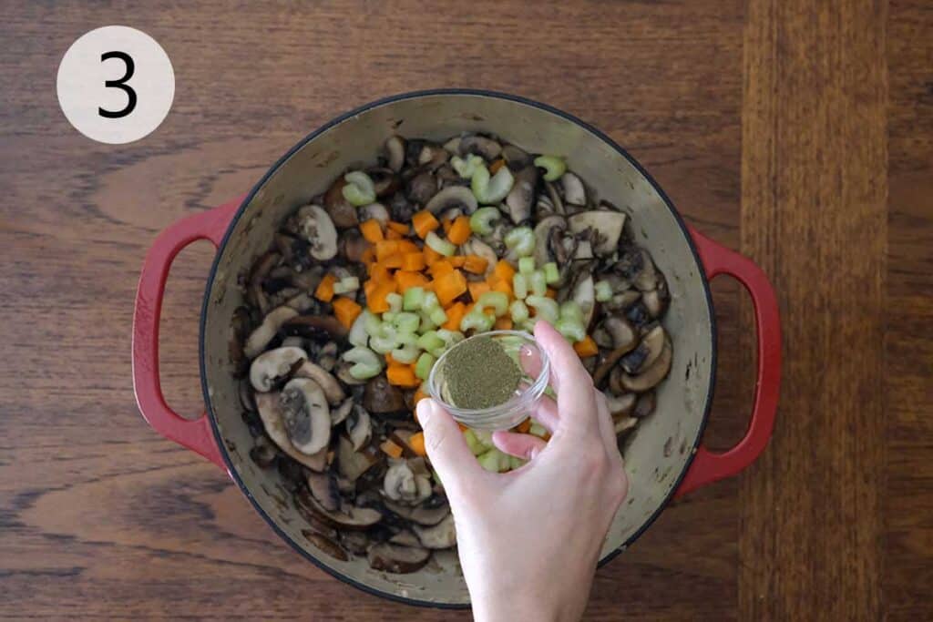 Diced carrots, celery, and thyme stirred into sautéed mushrooms for a rich and aromatic wild mushroom soup.