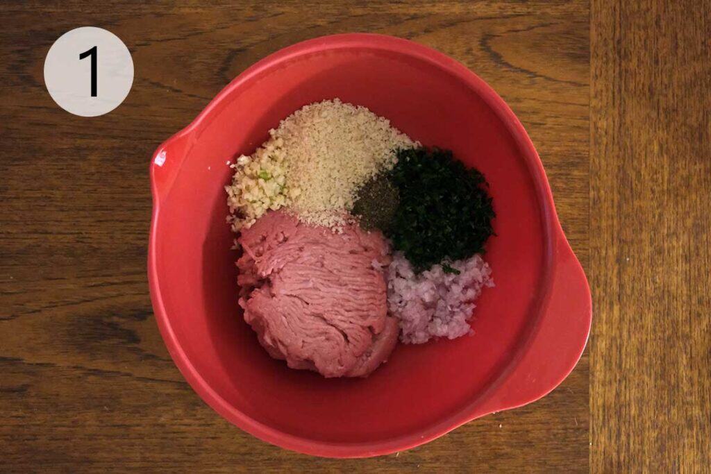 Ground turkey mixed with panko, herbs, garlic, egg, and seasonings in a bowl for homemade Turkey Meatball Soup Recipe.