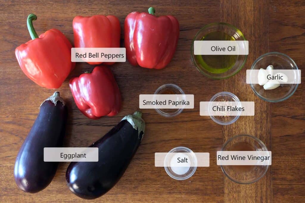 Ajvar recipe ingredients including red bell peppers, eggplant, garlic, olive oil, smoked paprika, chili flakes, salt, and red wine vinegar
