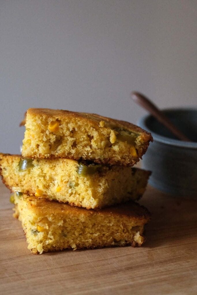 Homemade skillet jalapeño cornbread slices stacked to show golden crust and soft crumb