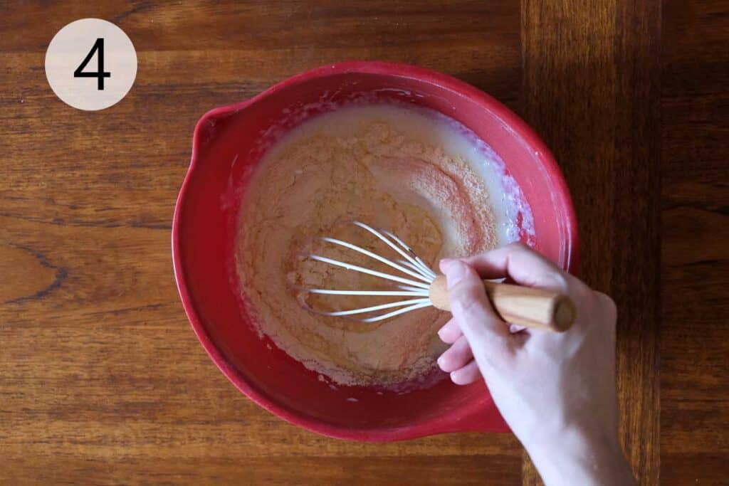 Mixing dry ingredients into wet ingredients to form jalapeño cornbread batter