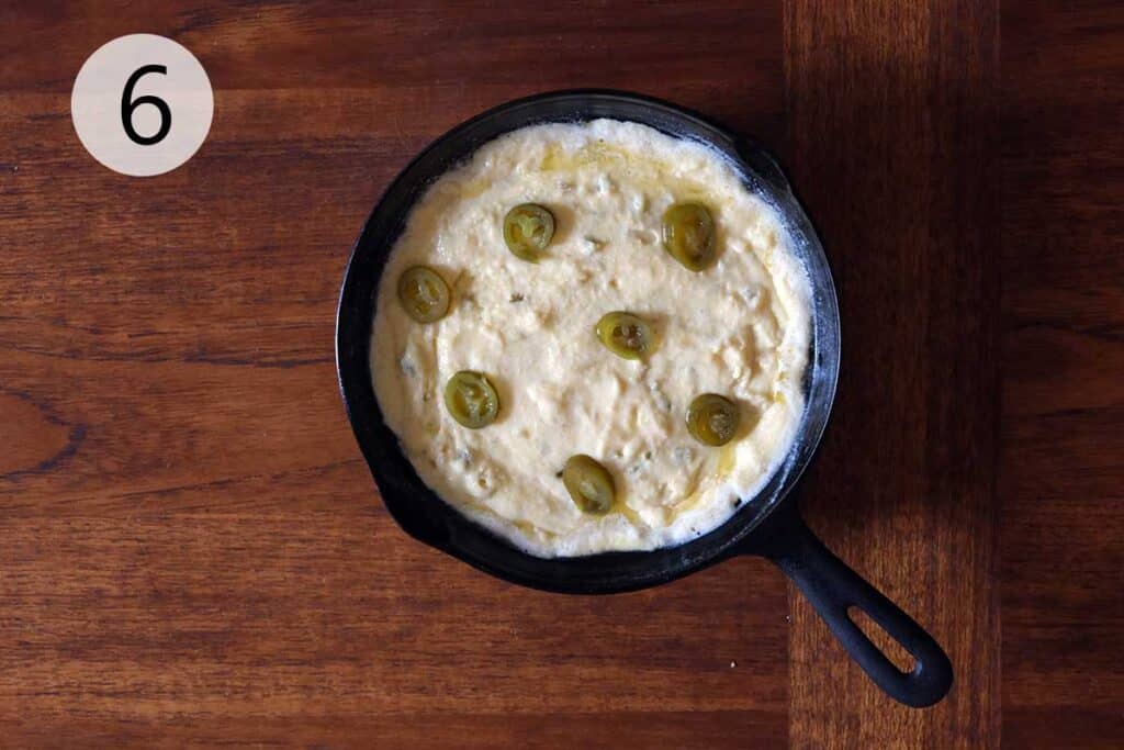 jalapeño cornbread batter in hot buttered cast iron skillet before baking